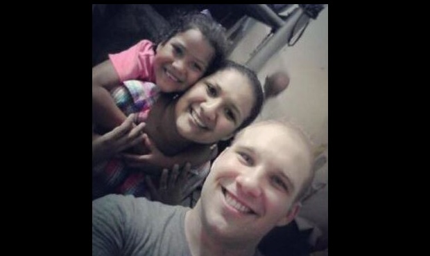 Josh Holt poses with his wife Thamy and her daughter Nathalia inside the prison at El Helicoide in ...