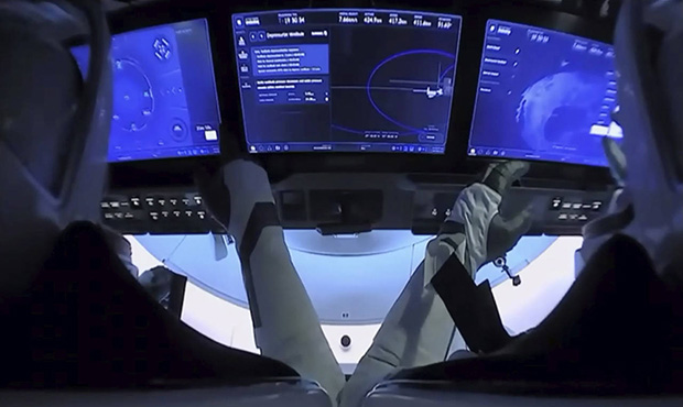 In this image from video made available by NASA, astronauts Doug Hurley, left, and Bob Behnken prep...