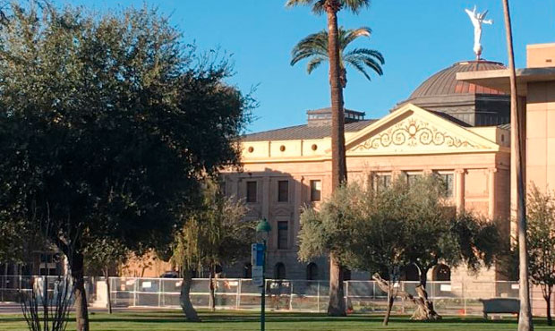 Fencing surrounds the Arizona State Capitol on the first day of the legislative session on Jan. 11,...