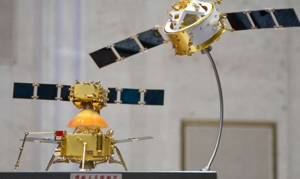 A model of China's Chang'e 5 lunar orbiter and lander are displayed before a press conference at th...