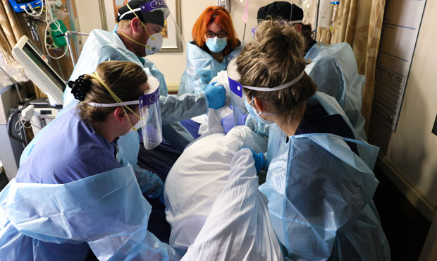 Clinicians re-position a COVID-19 patient into the supine position at Providence St. Mary Medical C...