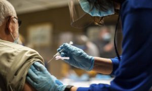 Average US virus cases dip below 100K for 1st time in months