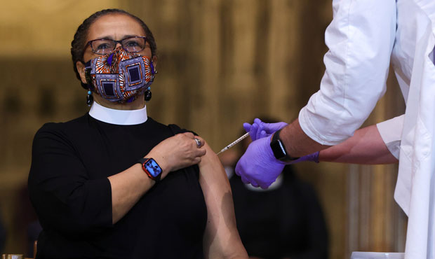 The Rev. Patricia Fears, Pastor of Fellowship Baptist Church in Washington, DC, receives a COVID-19...