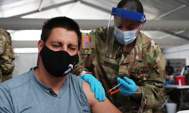 A U.S. Army soldier from the 2nd Armored Brigade Combat Team, 1st Infantry Division, immunizes Max ...