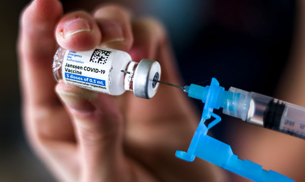 Adams 12 Five Star Schools District RN Tiffany Karschamroon draws a dose from a vial of the Johnson...