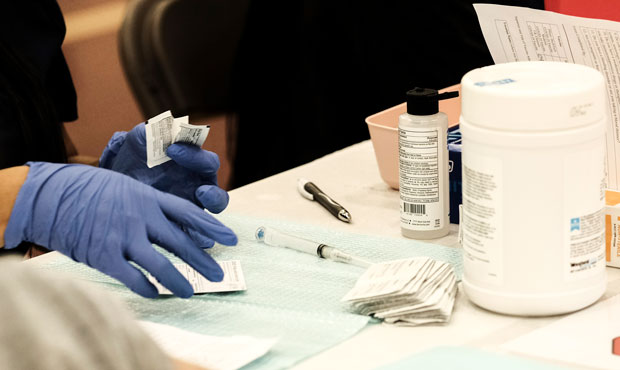 Volunteer medical staff administer COVID-19 vaccines to walk-in patients during a pop-up clinic at ...