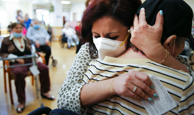 Executive director Margarita Kechichian (C) hugs a long-time resident during an Easter concert for ...