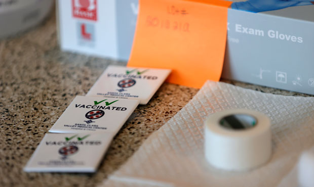 Pins that say "vaccinated" sit on a table during a vaccination clinic for Special Olympics athletes...