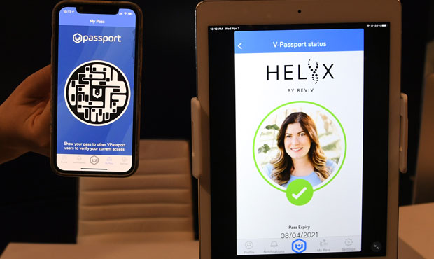 REVIV USA West Coast Operations Manager Kari Armamento uses a cell phone and an iPad to demonstrate...