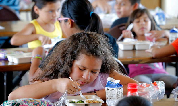 Children eat at free lunch youth program in Phoenix. (AP Photo, File)...