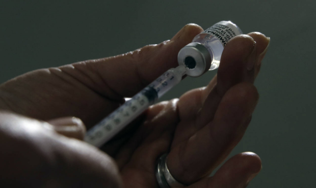 A medical staff prepares Pfizer's COVID-19 vaccine in a vaccination site in Sarcelles, outside Pari...