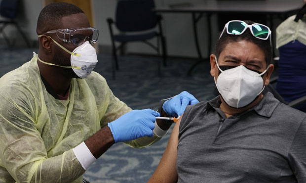 Gilmar Martiz, from Panama, gets a Pfizer-BioNtech COVID-19 vaccination from a health care worker a...