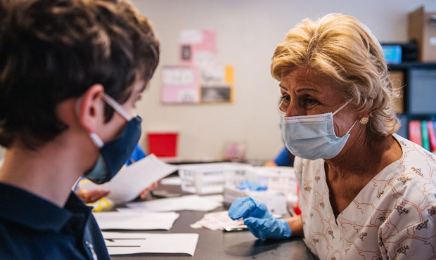 Registered nurse Marcie Weissman comforts a child ahead of his Covid-19 vaccination shot on May 13,...