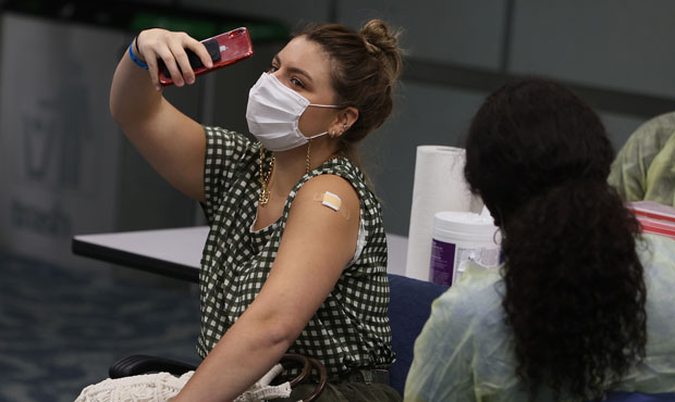 Maria Mercedes Sarmiento, from Peru, takes a selfie after getting a Pfizer-BioNtech COVID-19 vaccin...