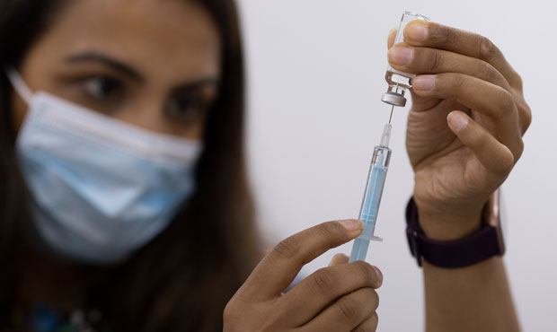 A volunteer draws the Astrazeneca vaccine as members of the public have their Covid-19 vaccinations...