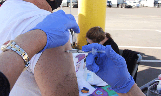 A Bashas’ worker gets a dose of the Johnson & Johnson vaccine during an event in March. Vaccinati...
