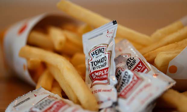 Packets of Heinz ketchup are displayed with Burger King french fries on April 12, 2021 in San Ansel...