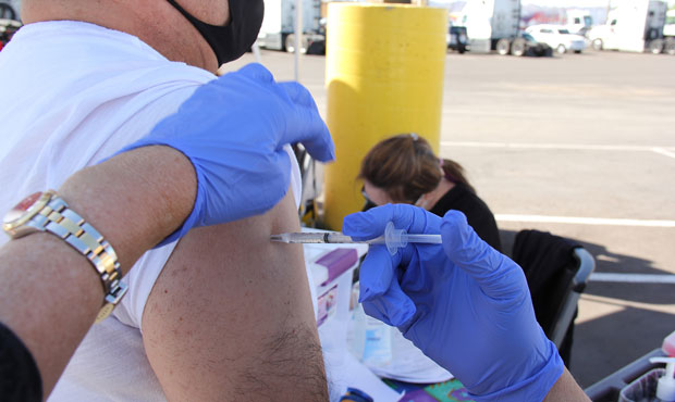A Bashas’ worker gets a dose of COVID-19 vaccine in March, when demand for vaccinations was high....