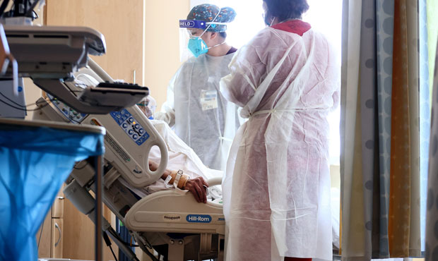 Caregivers tend to a patient in the improvised COVID-19 unit at Providence Holy Cross Medical Cente...