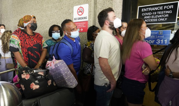 Passengers wait in a long line to get a COVID-19 test to travel overseas at Fort Lauderdale-Hollywo...