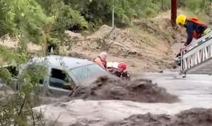 Watch: Crews rescue 3 from vehicle stuck in flooded Arizona wash