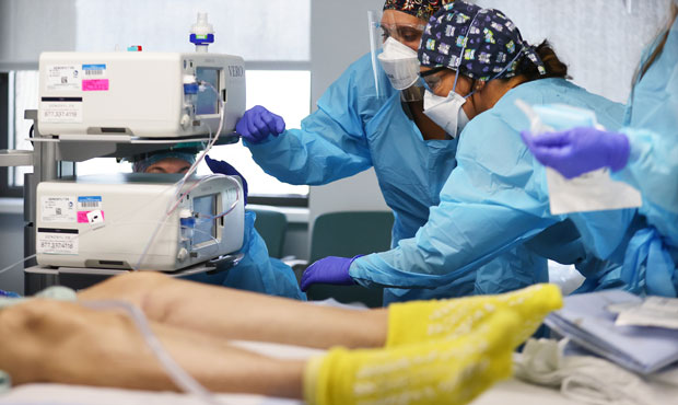 Clinicians work on intubating a COVID-19 patient in the Intensive Care Unit (ICU) at Lake Charles M...