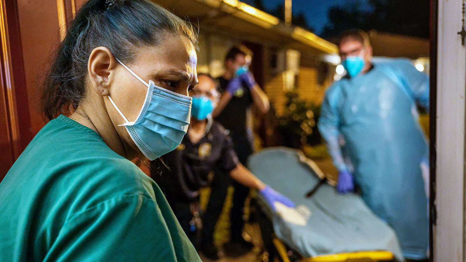 Houston Fire Department paramedics prepare to transport a woman, 52, to a hospital on August 25, 20...