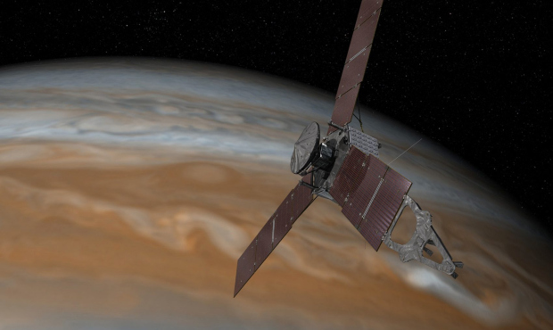 An artist's rendering made available by NASA/JPL-Caltech shows the Juno spacecraft above Jupiter. (...