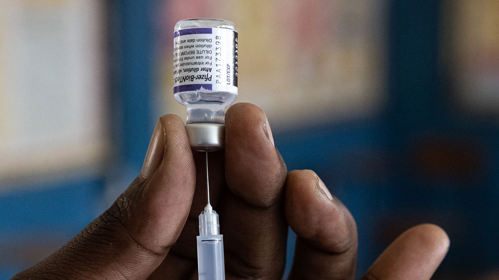 A nurse draws a dose of the Pfizer Coronavirus vaccine before injecting a patient at a school on Se...