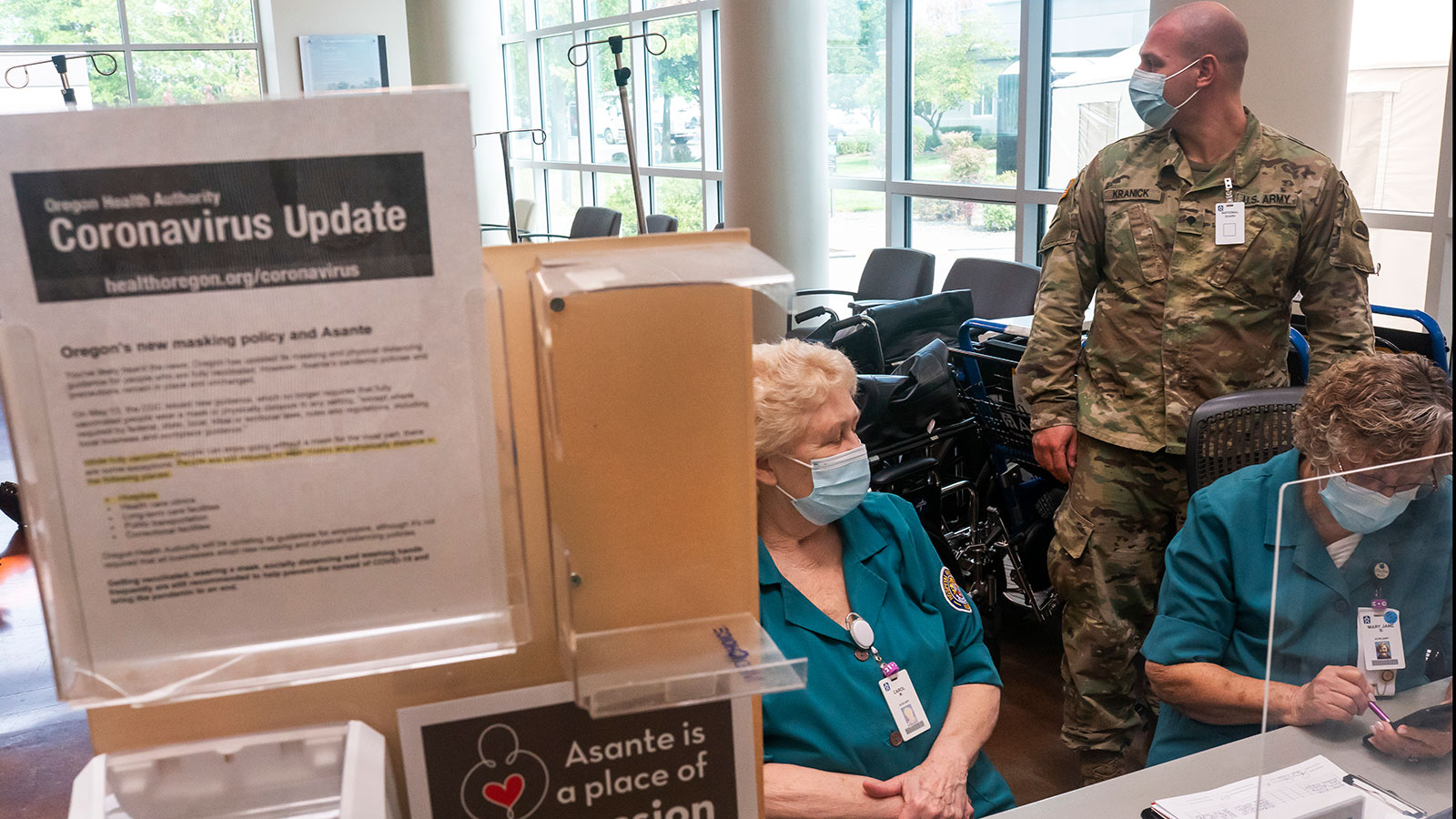 An Oregon National Guardsman works with hospital staff at an intake station at Three Rivers Asante ...