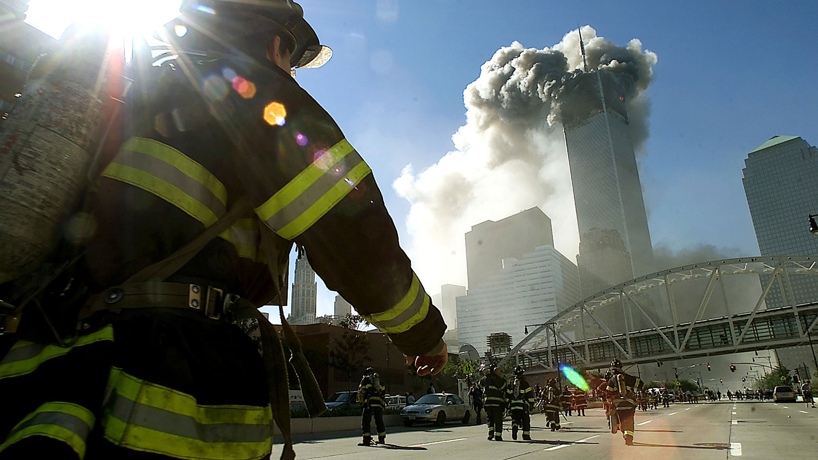 Firefighters walk toward one of the towers at the World Trade Center before it collapsed after a pl...