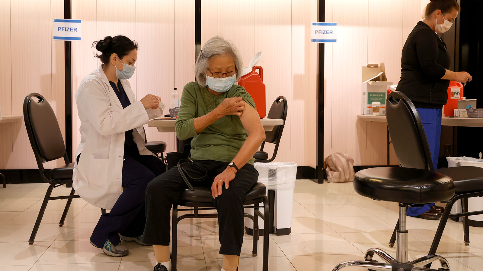A pharmacist prepares to give a Pfizer COVID-19 vaccination at a booster shot clinic on Oct. 1, 202...