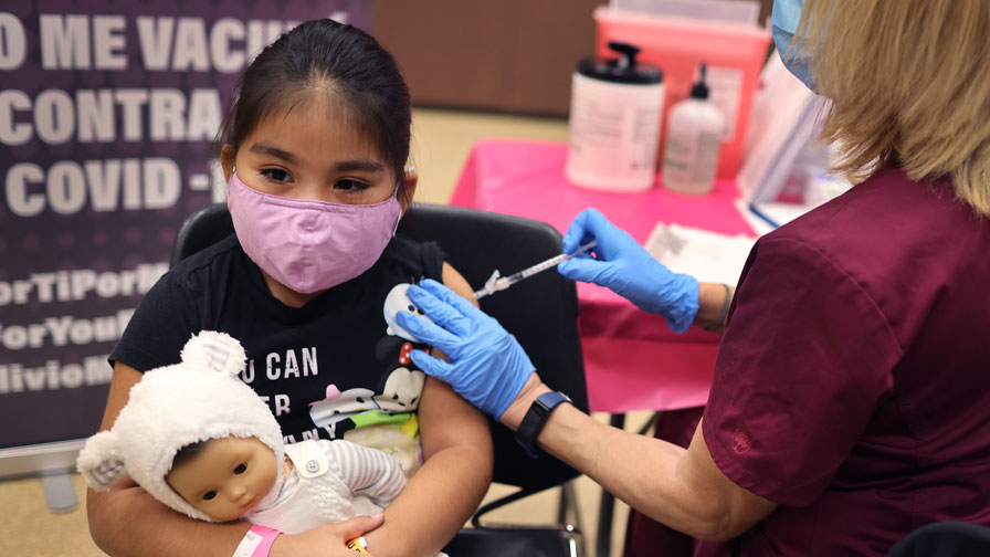 First grade student, seven-year-old Rihanna Chihuaque, receives a covid-19 vaccine at Arturo Velasq...
