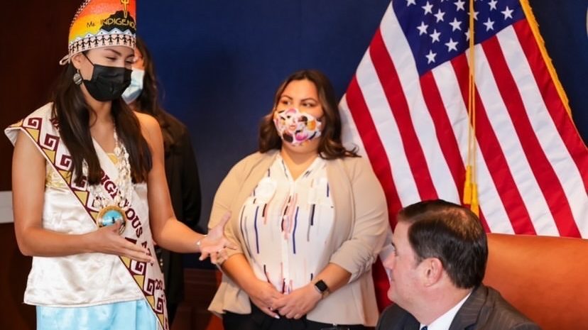 Lourdes Pereira stands next to Gov. Doug Ducey on Sept. 1 as he signs House Bill 2705, which preven...