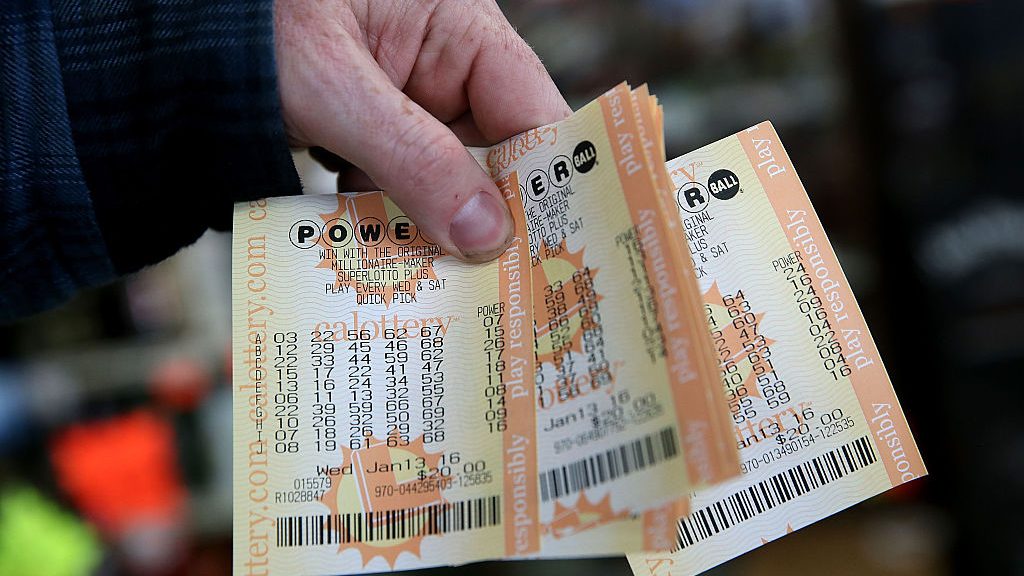 A customer holds a handful of Powerball tickets at Kavanagh Liquors on January 13, 2016 in San Lore...