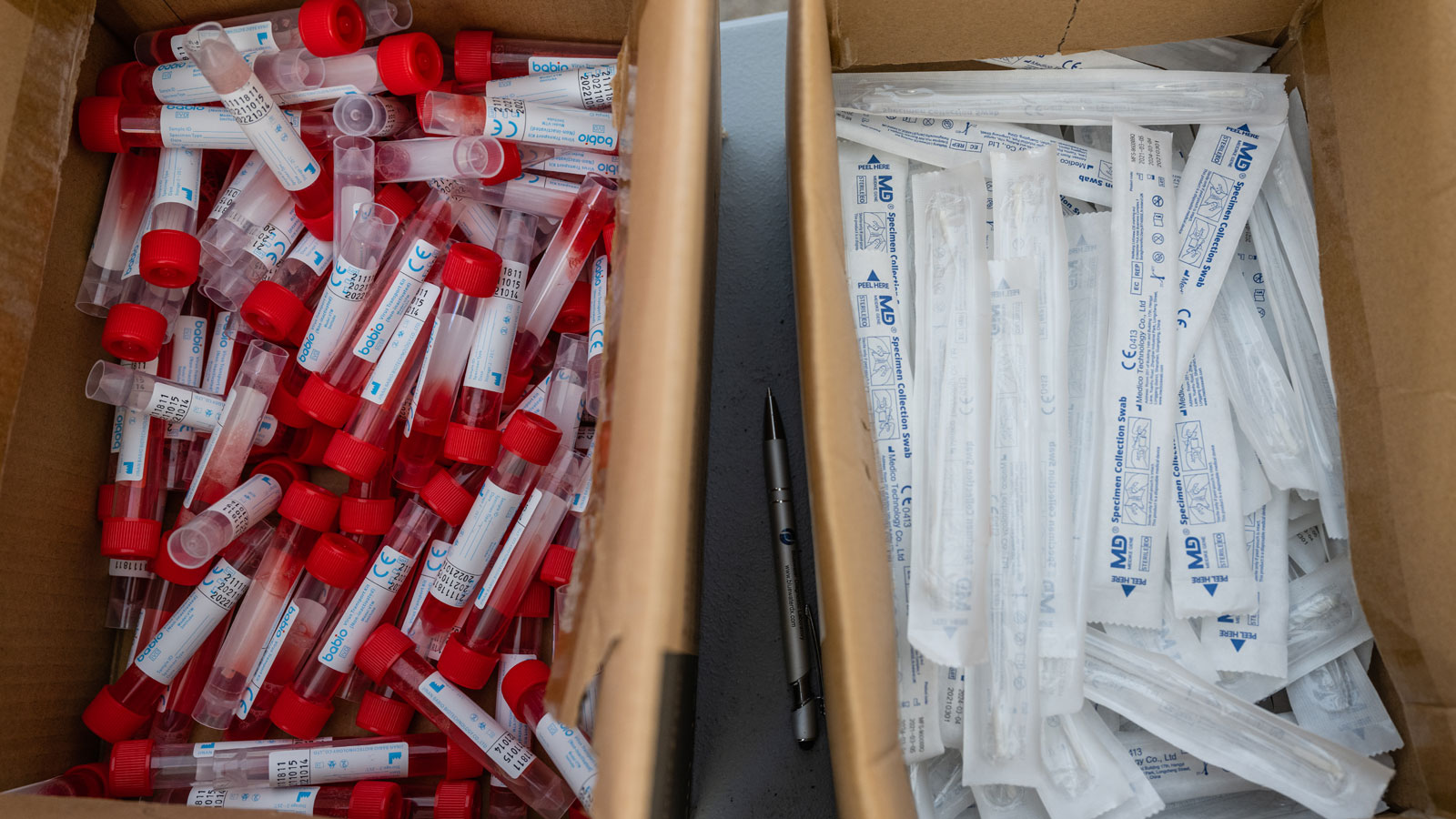 Vials of testing fluid and packages of nose swabs are seen at a drive through COVID-19 testing site...