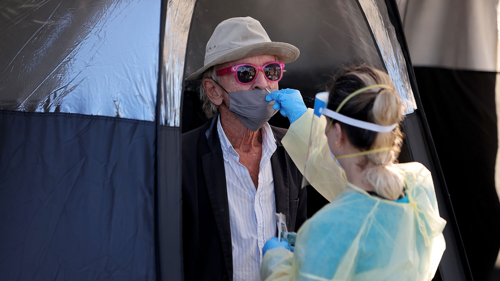 Robert Emmerling gets a COVID-19 test done by a healthcare worker on Jan. 13, 2022, in North Miami,...