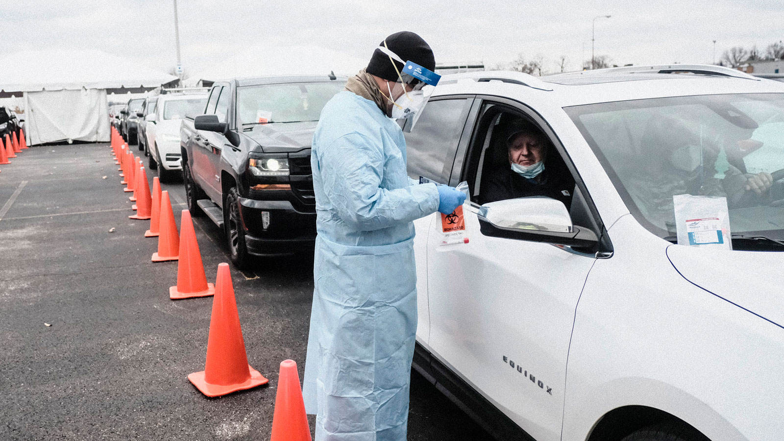 Members of the Ohio National Guard administer COVID-19 swab tests at a drive through testing site o...