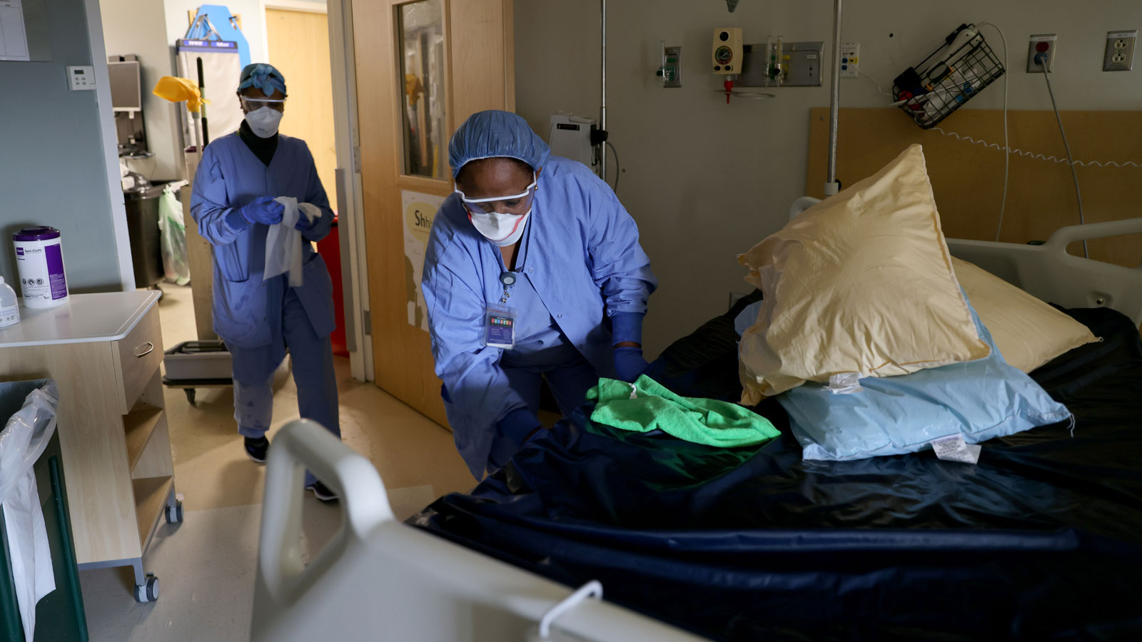 Environmental Services workers Haimanot Gebre (L) and Aster Mekonen deep clean a non-COVID room wit...