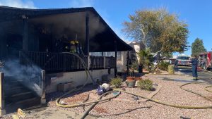 Firefighter hospitalized with minor injuries following double mobile home fire in Phoenix