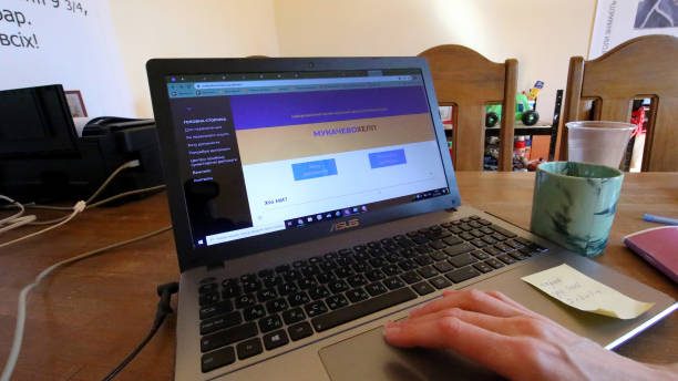 MUKACHEVO, UKRAINE - MARCH 22, 2022 - A worker touches the laptop at the call centre of the Mukache...