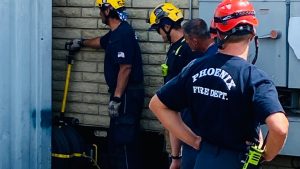 Firefighters in Phoenix use powerful airbag to free man trapped between shipping container, brick wall