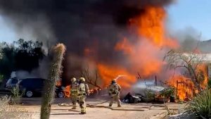 2 hospitalized after fire tears through 2 houses in north Phoenix
