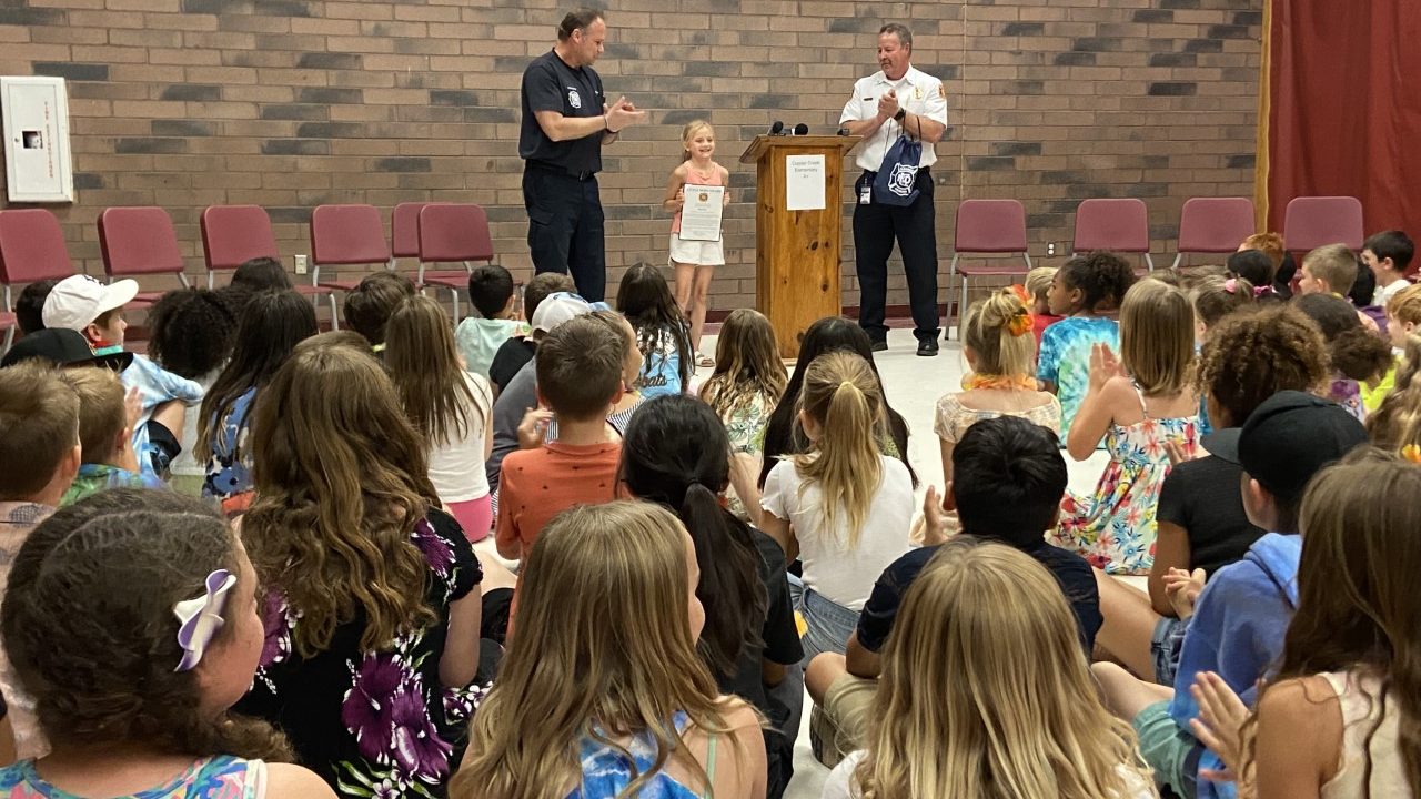 Rhae Parks receives an award for helping her siblings get out of their house during a fire. (KTAR N...