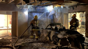 Fire destroys car but Phoenix crews stop flames from taking down house