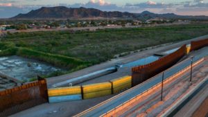 Shipping containers wait in Arizona community before going to border