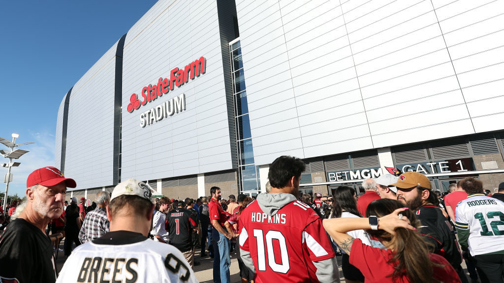Fans line up to enter the stadium prior to the game between the New Orleans Saints and the Arizona ...