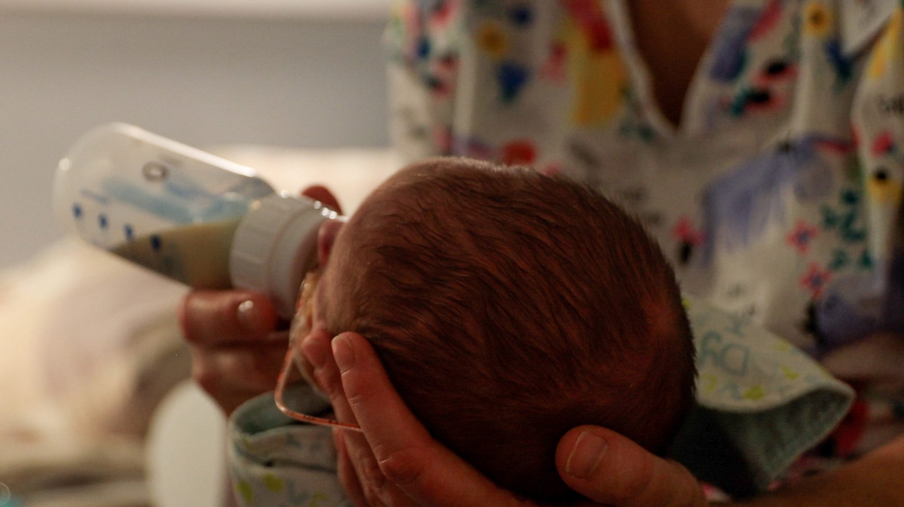 A staff member at Hushabye Nursery in Phoenix feeds one of the babies on Nov. 8, 2022. Infants brou...