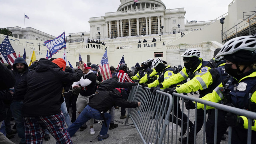 FILE - Insurrectionists loyal to President Donald Trump try to break through a police barrier, Wedn...