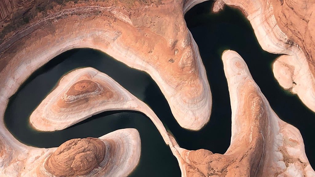 A June 2021 photo of Reflection Canyon, upstream of Lake Powell showing the “bathtub ring” of w...